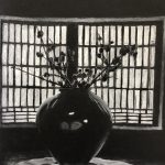 Vase with flowers in front of window