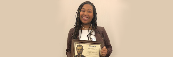 Amani Gates holding her award