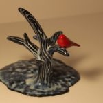 Sculpture of red cardinal on small tree