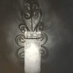 Candle in sconce