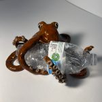 Ceramic snake wrapping around a plastic water bottle