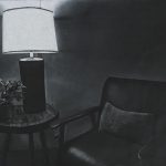 Lamp on end table with chair