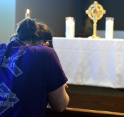 Student praying in the chapel