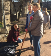 girls raking leaves