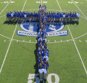 Cross made out of students on the stadium field