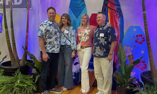 4 attendees in tropical attire