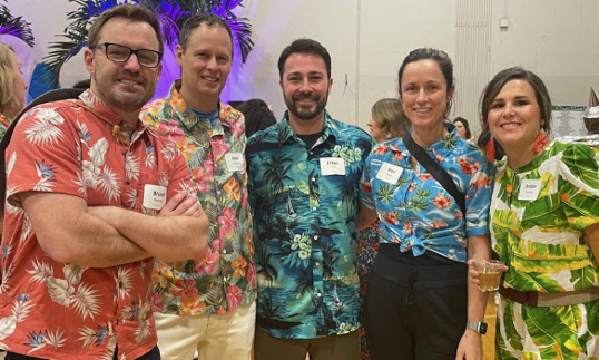 5 attendees in tropical attire